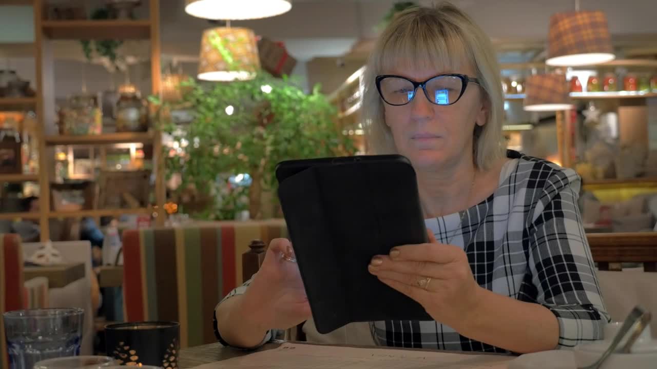   Stock Footage Woman Browsing A Tablet Before Ordering Live Wallpaper