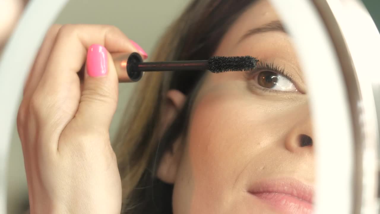   Stock Footage Woman Applies Mascara Live Wallpaper