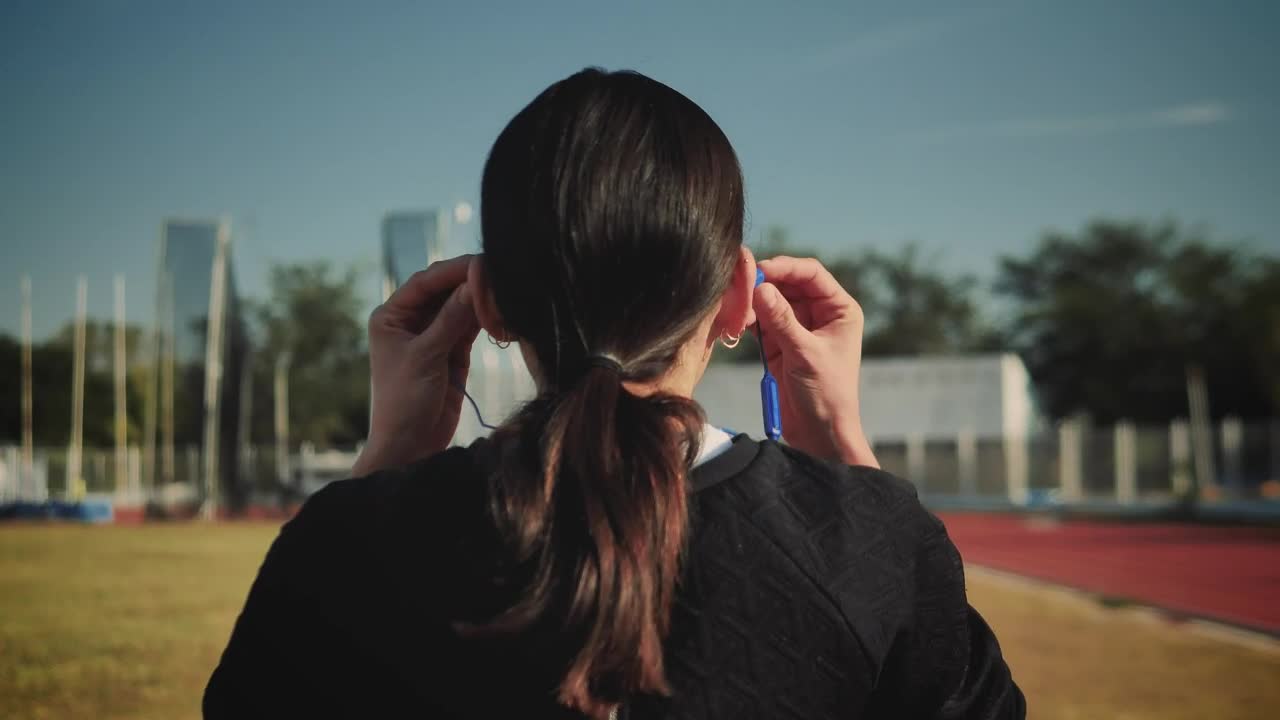   Stock Footage Woman Adjusting Her Headphones To Start Running Live Wallpaper