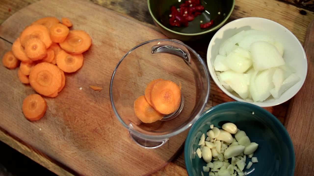   Stock Footage Woman Adding Chopped Carrots To A Bowl Live Wallpaper