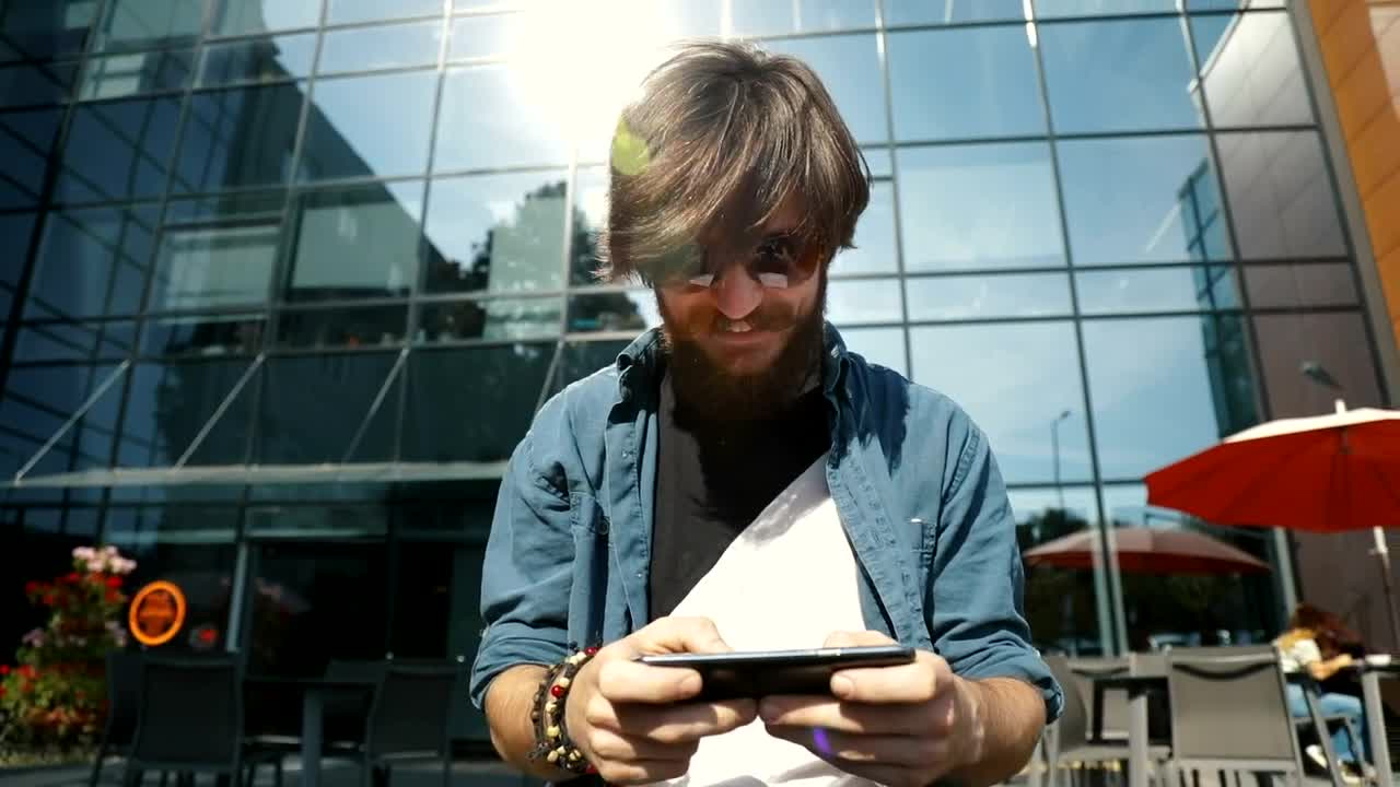   Stock Footage Winner Celebrates Victory In Mobile Game On City Street Live Wallpaper