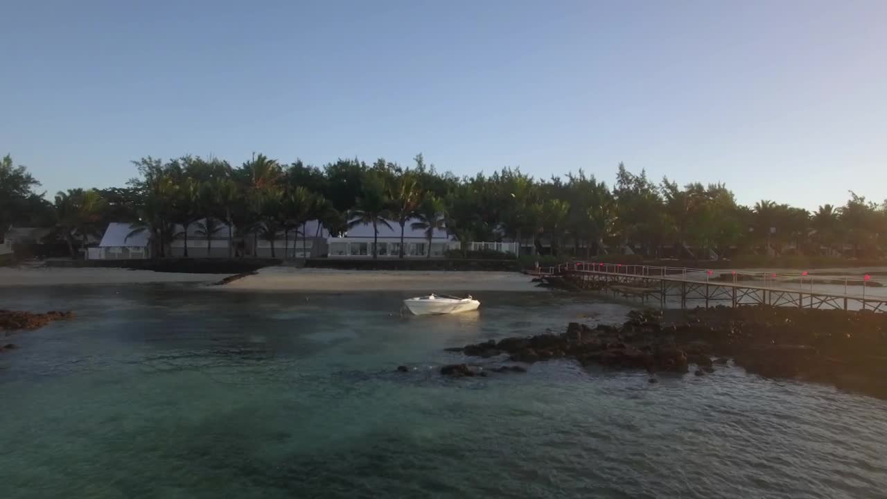   Stock Footage White Boat Anchored By A Small Beach Live Wallpaper