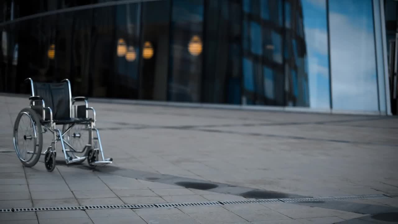   Stock Footage Wheelchair Walking Alone On The Sidewalk Live Wallpaper