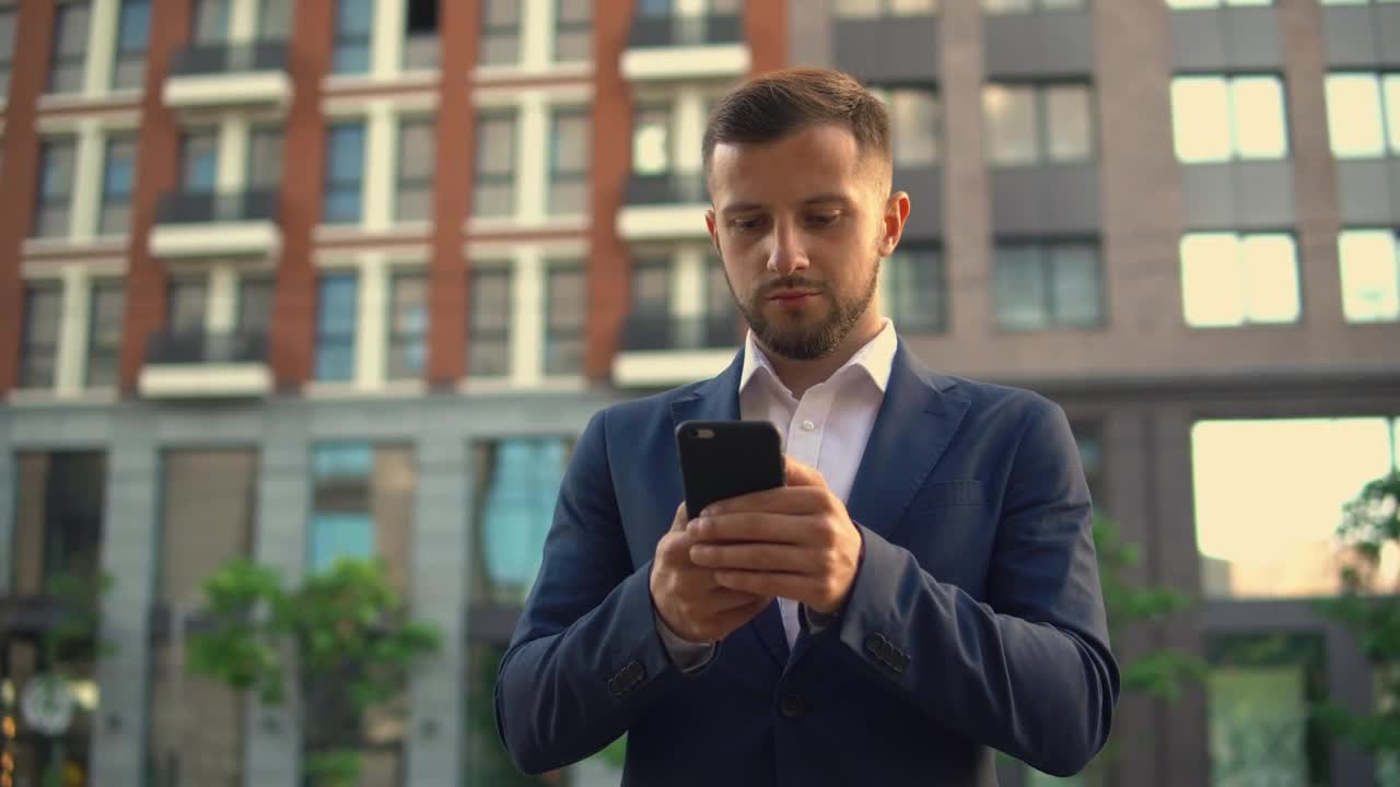   Stock Footage Well Dressed Businessman Sending Messages On His Cell Phone Live Wallpaper