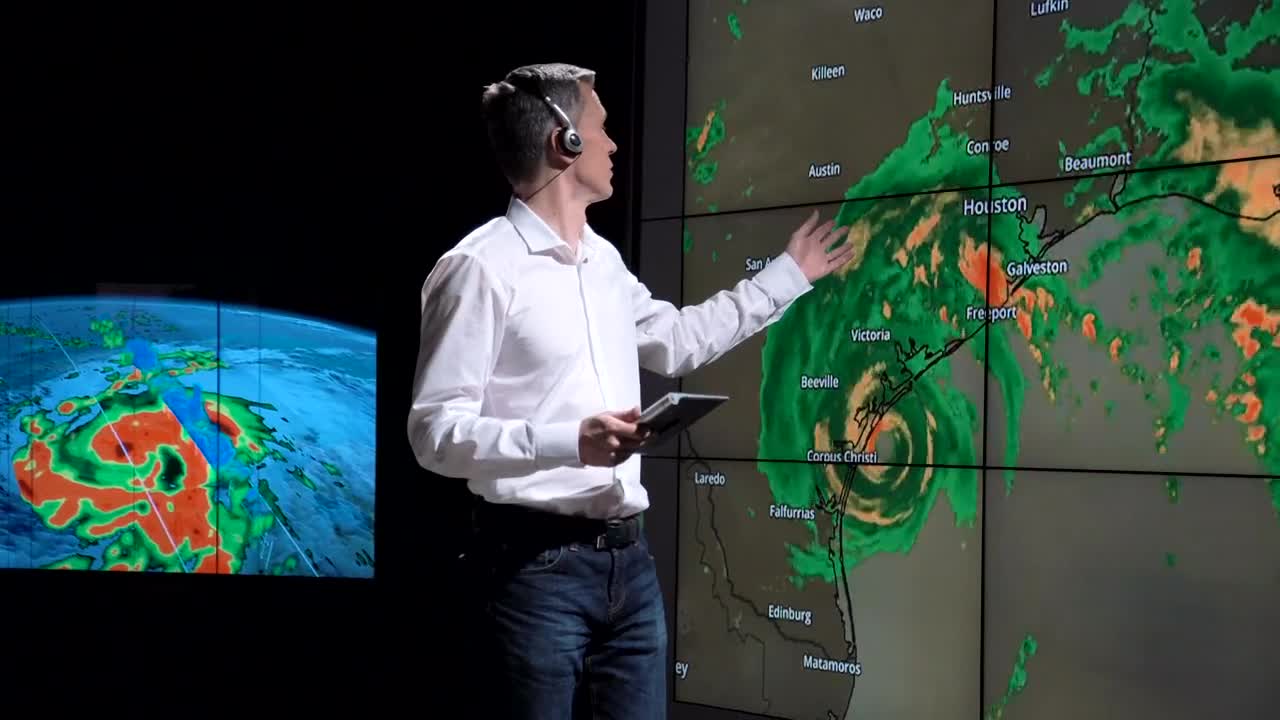   Stock Footage Weatherman Showing A Hurricane On The Screen Live Wallpaper