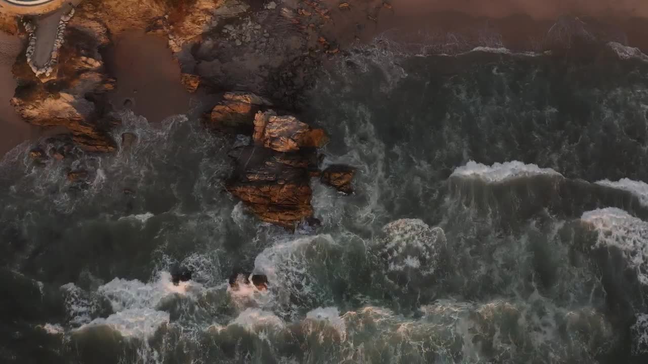   Stock Footage Waves Crash On A Shore With Boulders Live Wallpaper