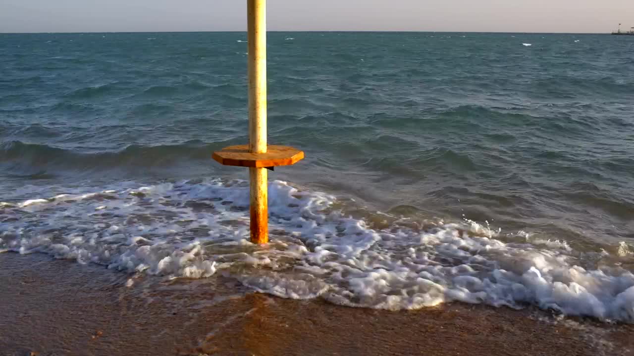   Stock Footage Waves Breaking Around An Umbrella Live Wallpaper