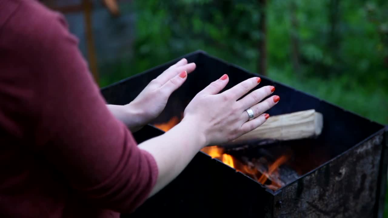   Stock Footage Warming Her Hands Over A Fire Live Wallpaper