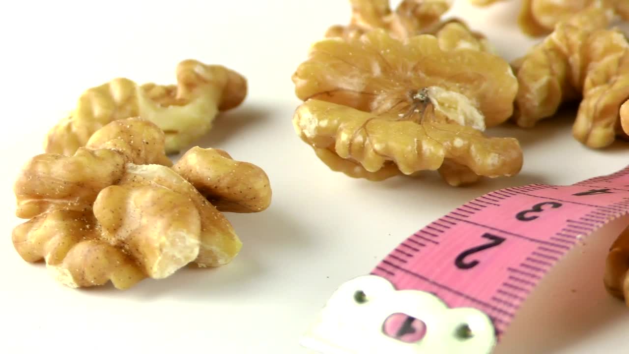   Stock Footage Walnuts And Measure Tape On White Table Live Wallpaper