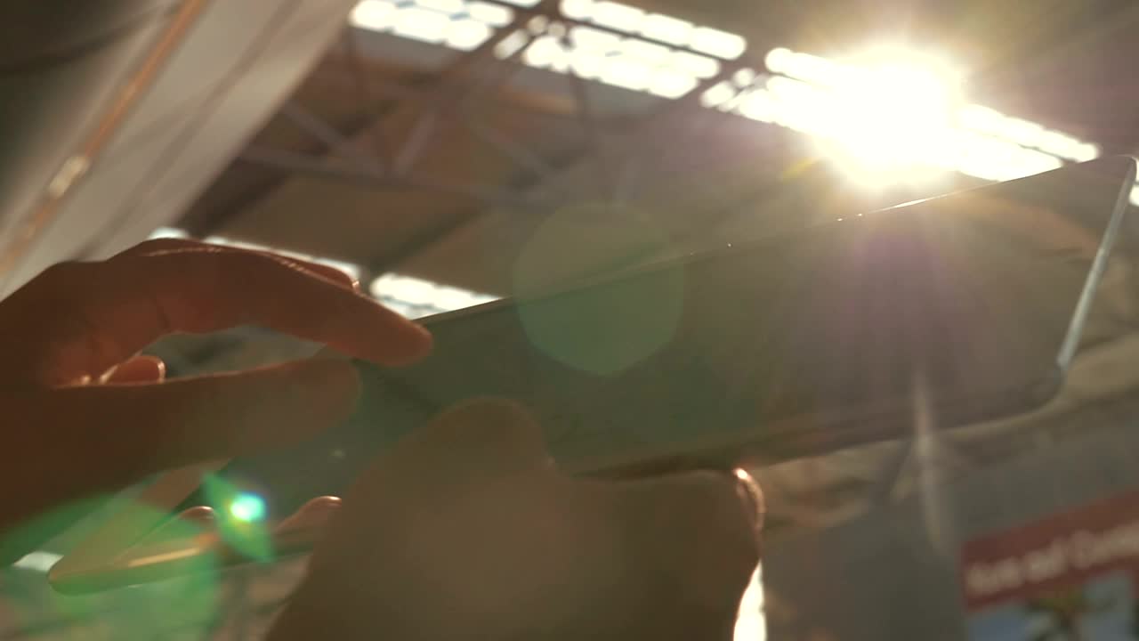   Stock Footage Using A Tablet Under Bright Sunshine Live Wallpaper