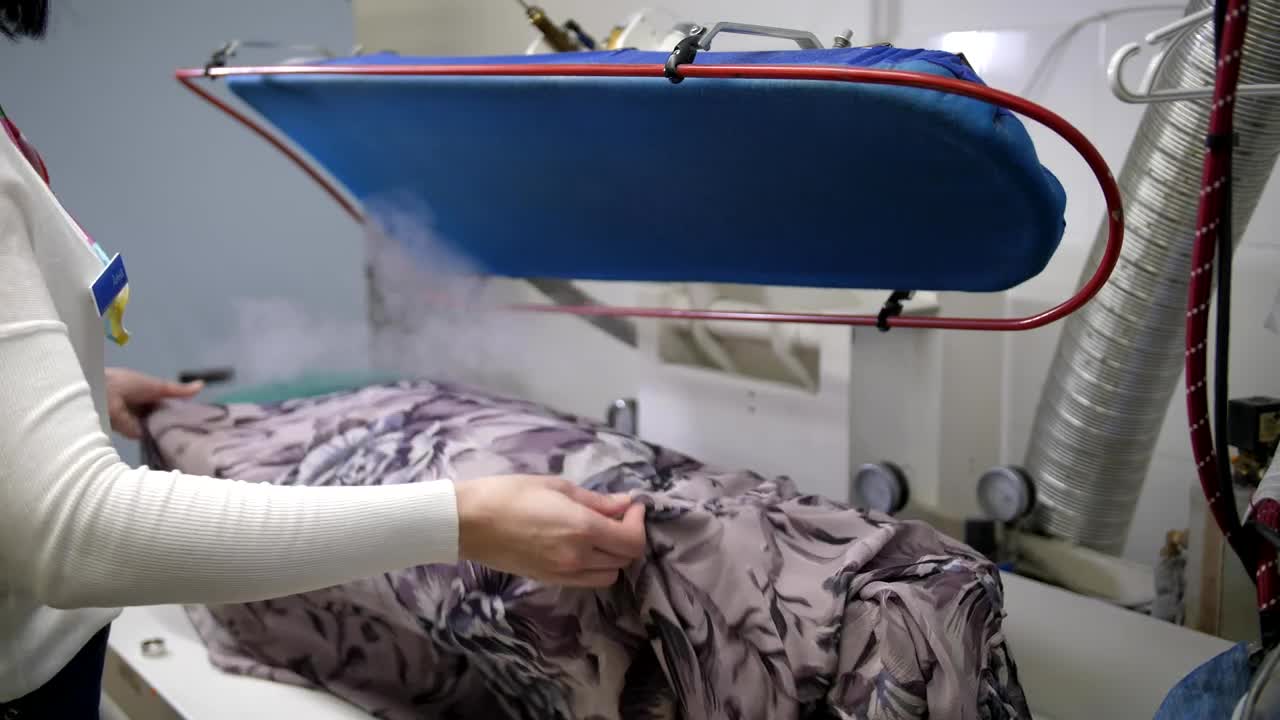   Stock Footage Using A Steam Cleaner On A Dress Live Wallpaper