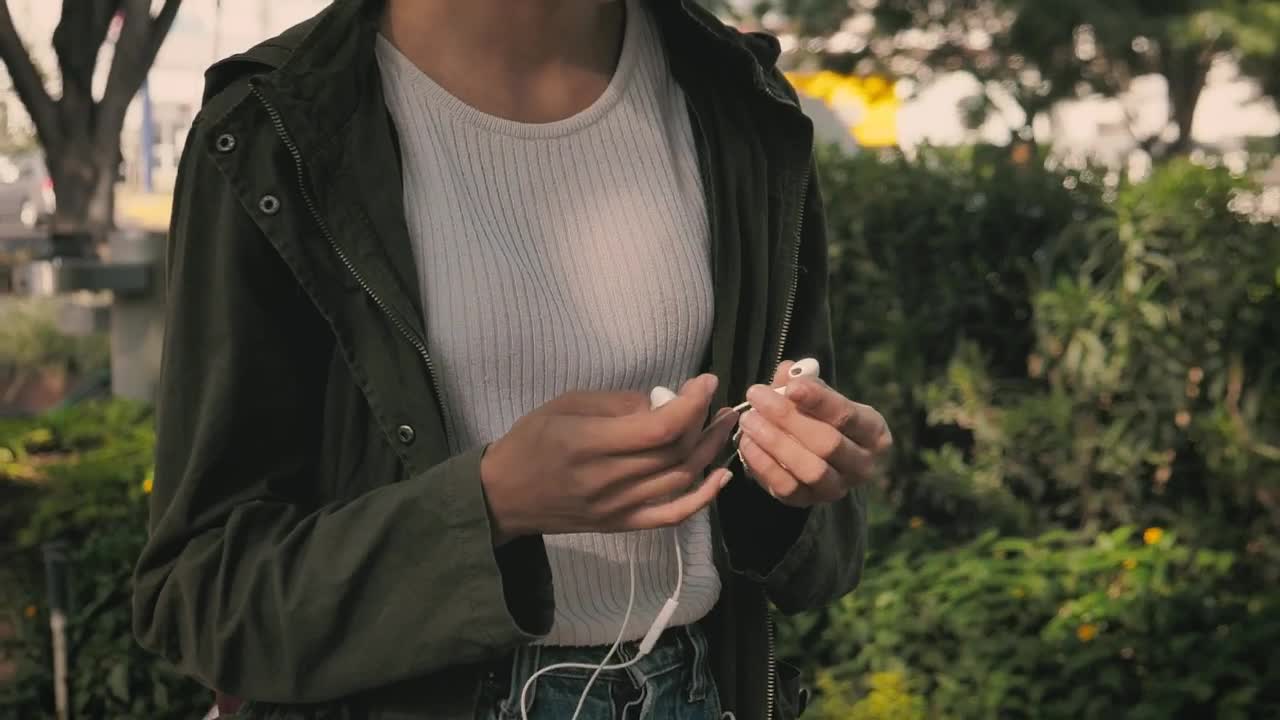   Stock Footage Urban Woman Putting On Her Headphones While Walking Live Wallpaper
