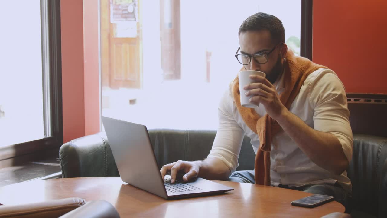   Stock Footage Urban Man Sips Coffee While Working In Cafe Live Wallpaper