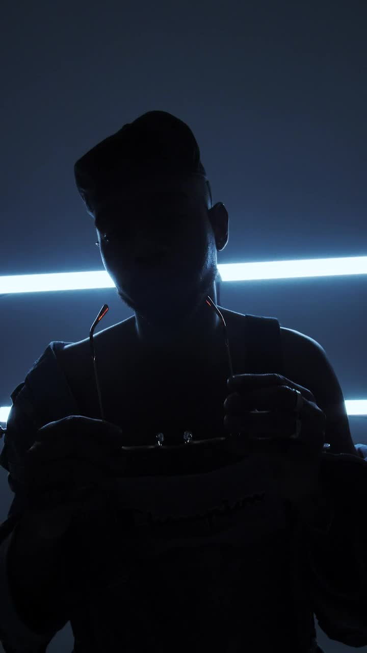   Stock Footage Urban Man Puts On A Glasses At A Dark Room Live Wallpaper