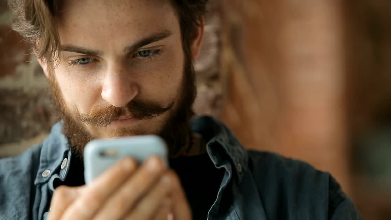   Stock Footage Urban Man Browses Web On Mobile Phone Live Wallpaper
