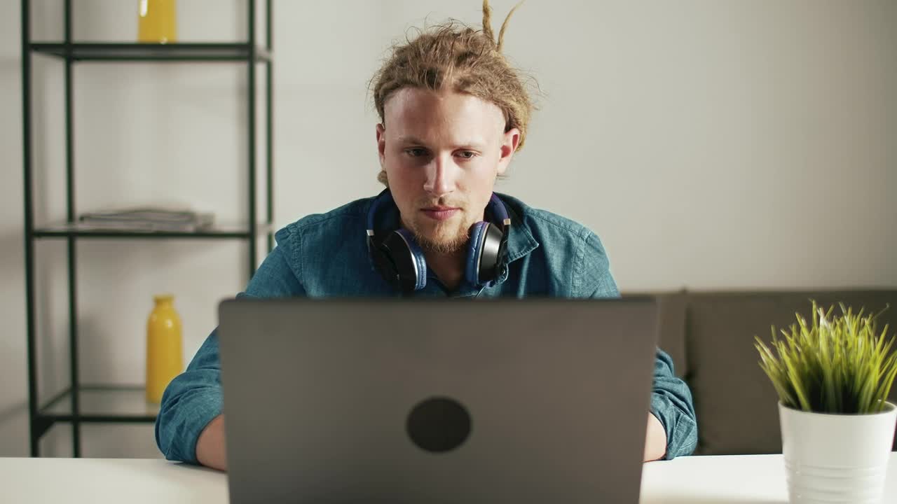   Stock Footage Urban Man Browses Web On Laptop With Headphones Live Wallpaper
