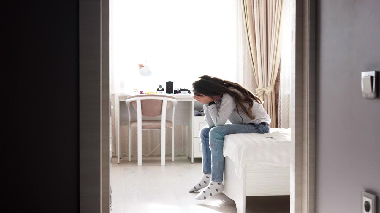   Stock Footage Upset Girl Sitting On Her Bed Live Wallpaper