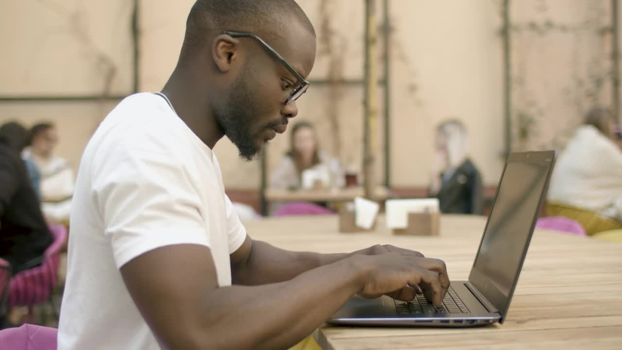   Stock Footage University Student Types On Laptop In Outdoor Cafe Live Wallpaper