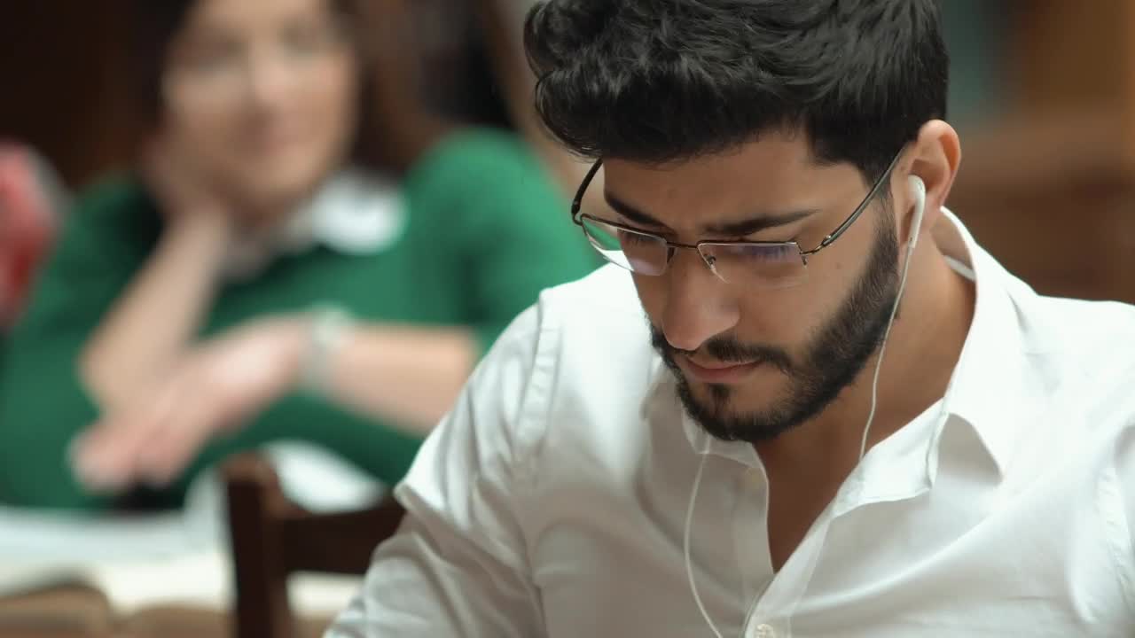   Stock Footage University Student Studies With Earphones In Closeup Live Wallpaper
