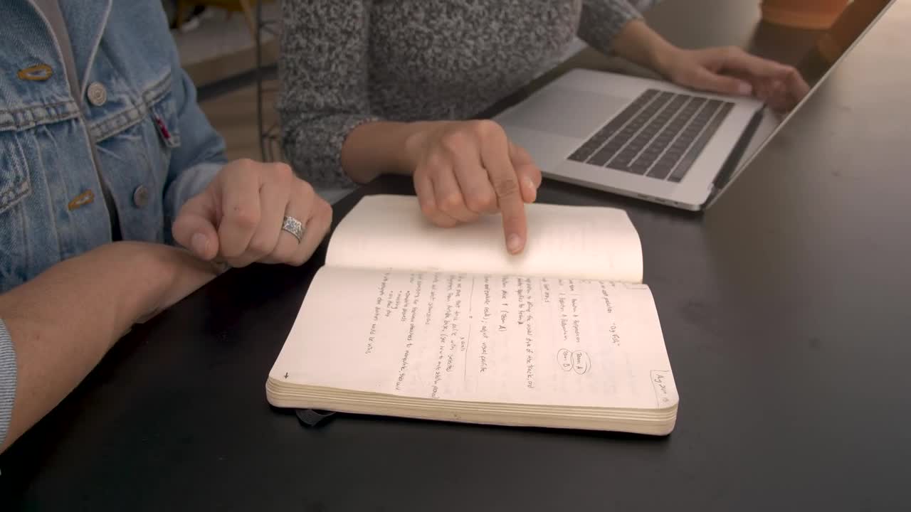   Stock Footage Two People Working On A Black Table Live Wallpaper