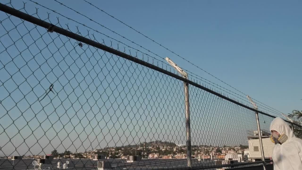   Stock Footage Two People With Gas Masks Disinfecting A Fence Live Wallpaper