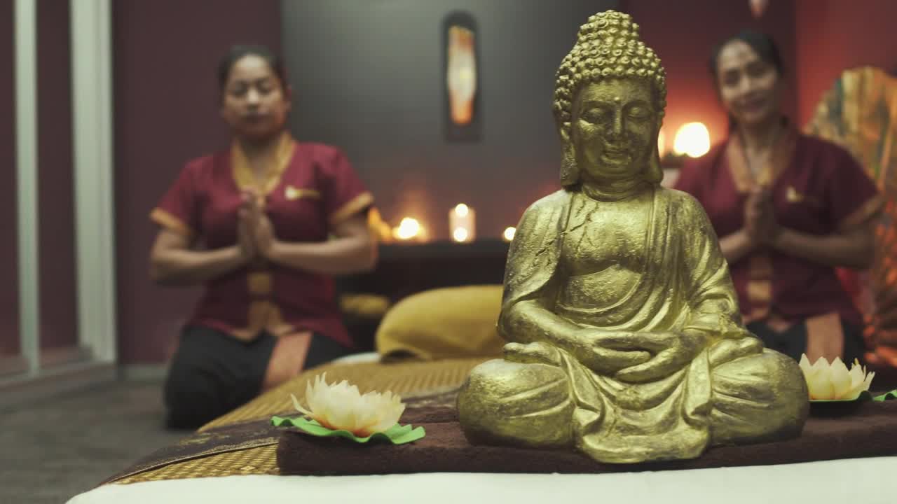   Stock Footage Two Monks Kneeling Behind Golden Buddha Live Wallpaper