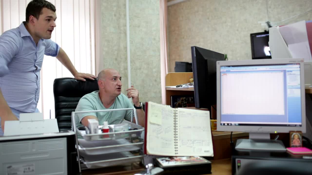   Stock Footage Two Men Working In A Small Office Live Wallpaper