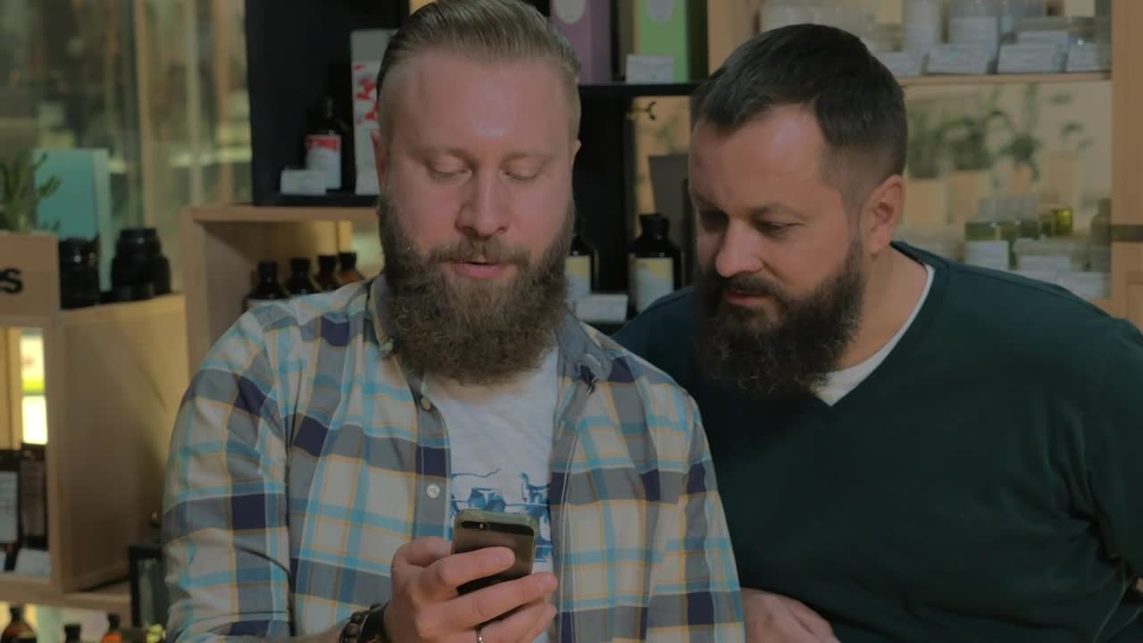   Stock Footage Two Men With Beards Checking A Phone Live Wallpaper
