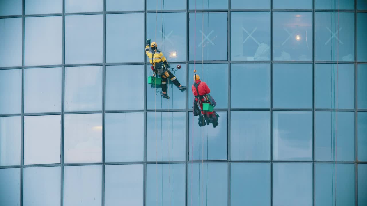   Stock Footage Two Men In Red And Yellow Work Clothes Cleaning The Live Wallpaper