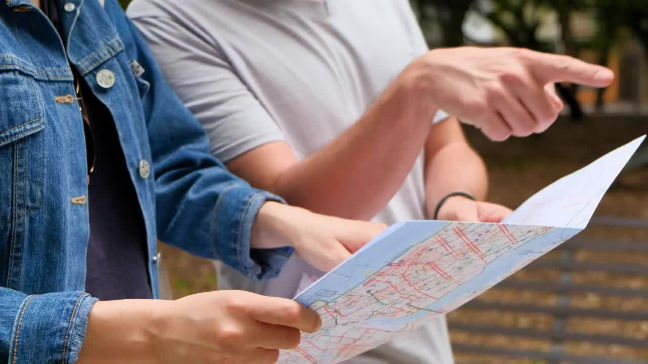   Stock Footage Two Friends Walking Through A Park While Looking At A Live Wallpaper