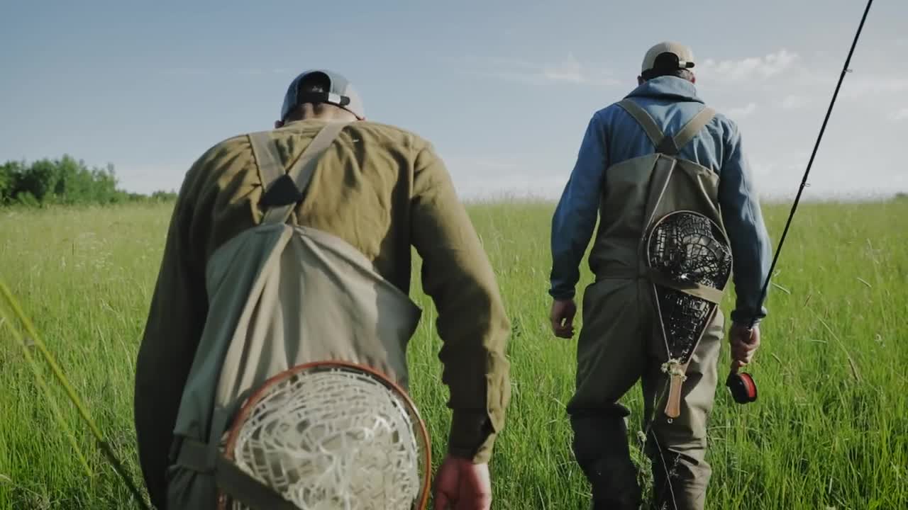   Stock Footage Two Fishermen Walking In High Grass Live Wallpaper