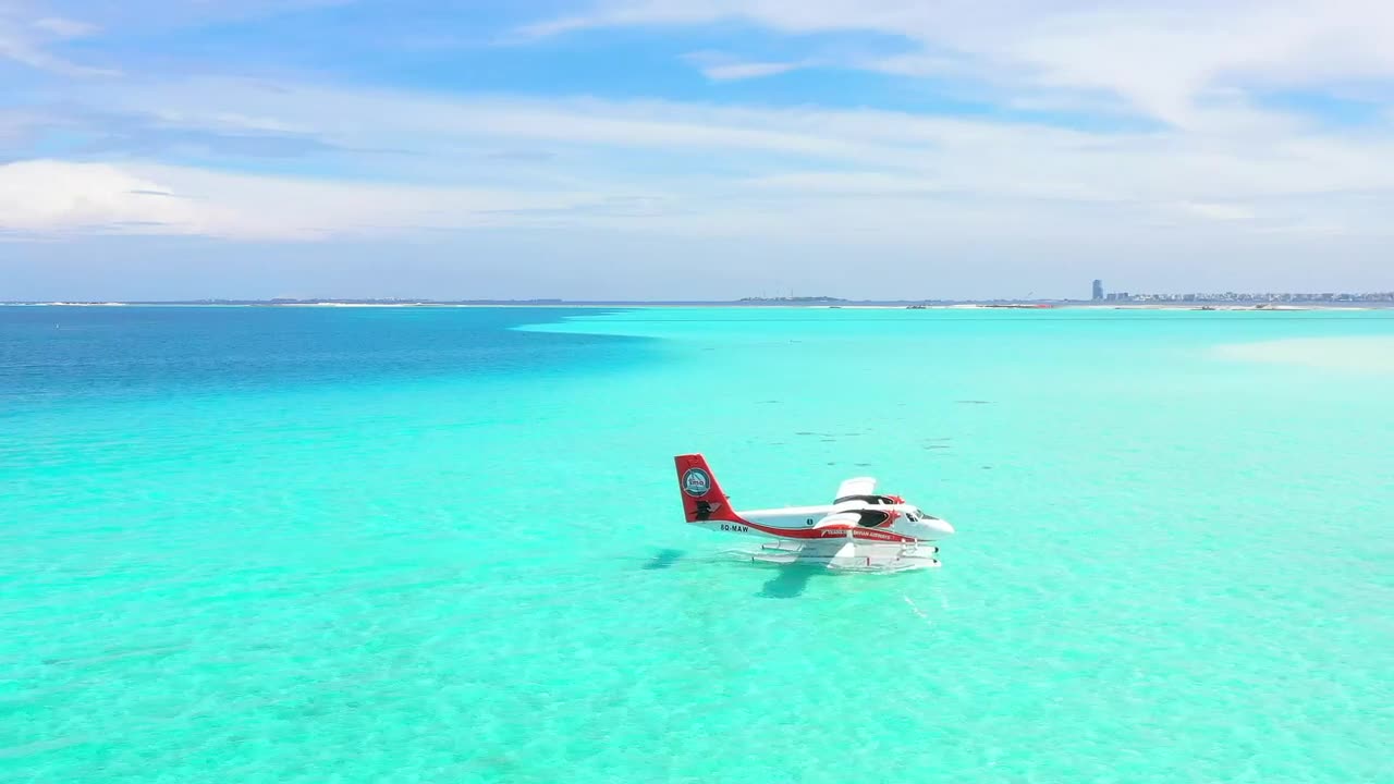   Stock Footage Turquoise Sea With A Plane Floating Live Wallpaper