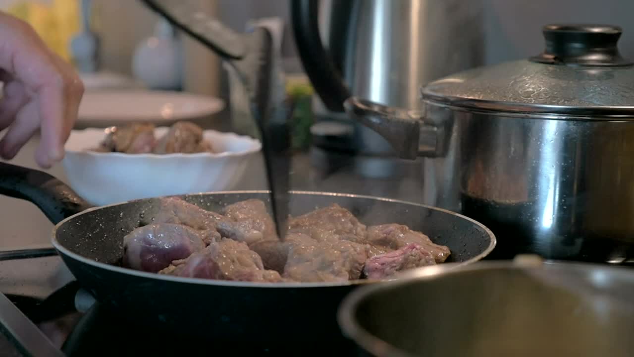   Stock Footage Turning Meat In A Frying Pan Live Wallpaper