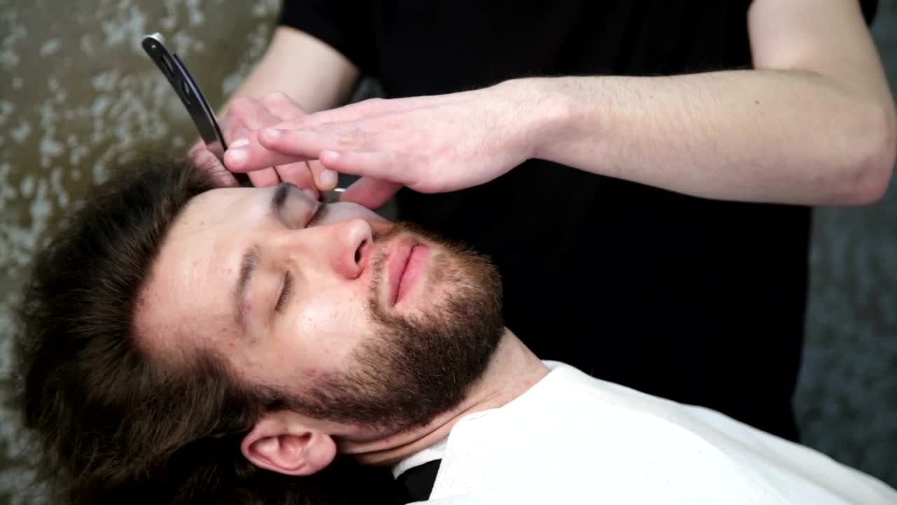   Stock Footage Trimming A Beard With A Razor Live Wallpaper