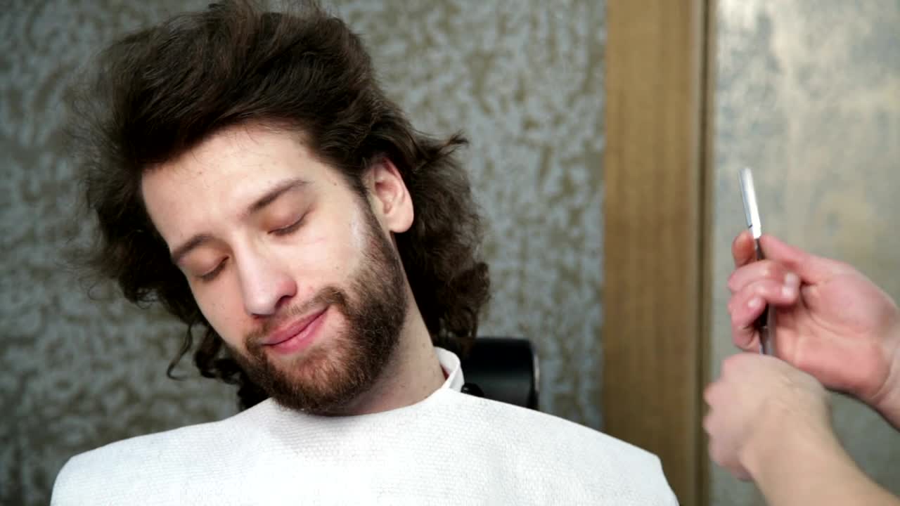   Stock Footage Trimming A Beard With A Razor Close Up Live Wallpaper