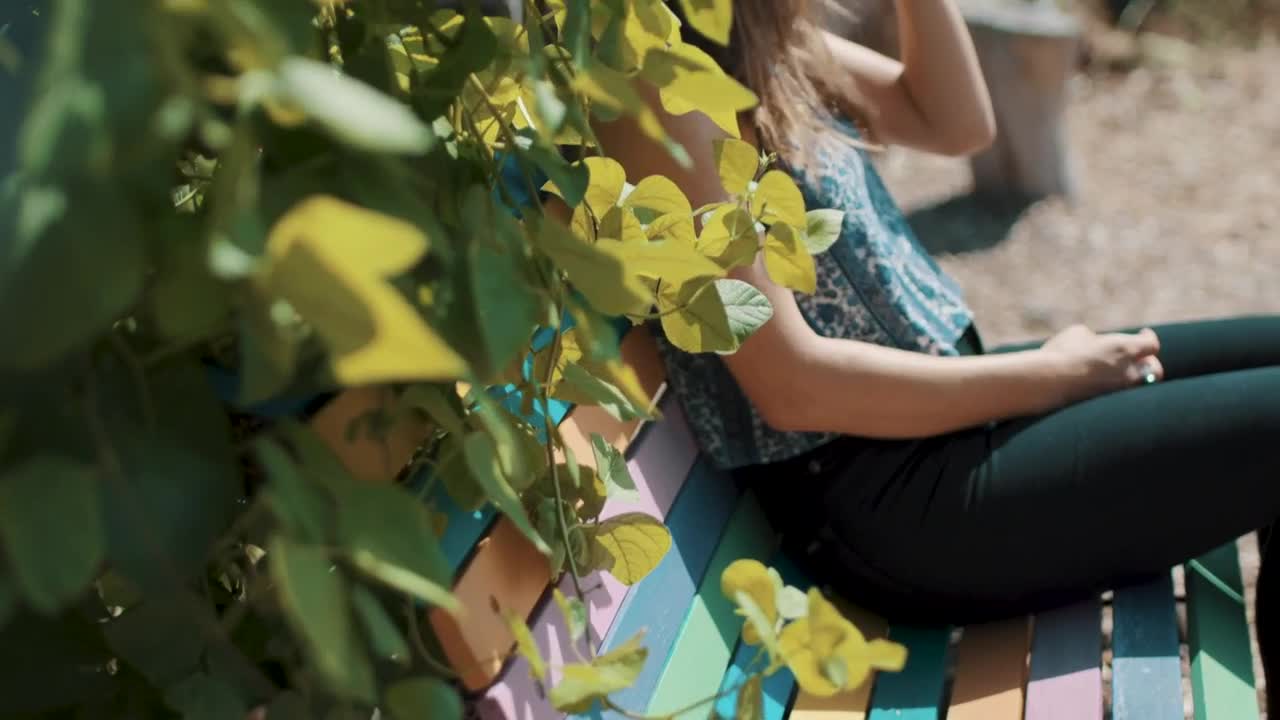 Stock Footage Woman Resting On A Garden Bench Live Wallpaper Free