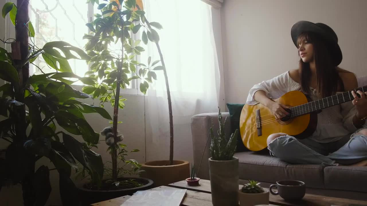 Stock Footage Woman Playing An Acoustic Guitar In Her Living Room Live Wallpaper Free