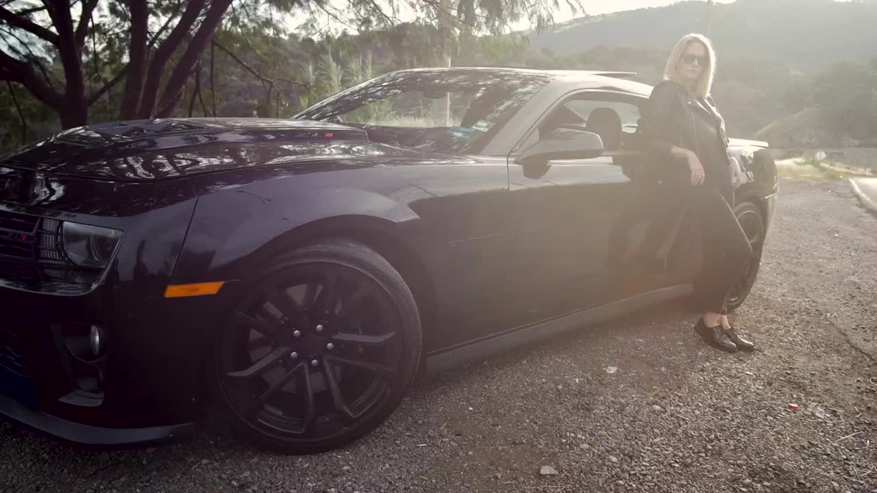 Stock Footage Woman Leaning Against Luxury Black Car Live Wallpaper Free