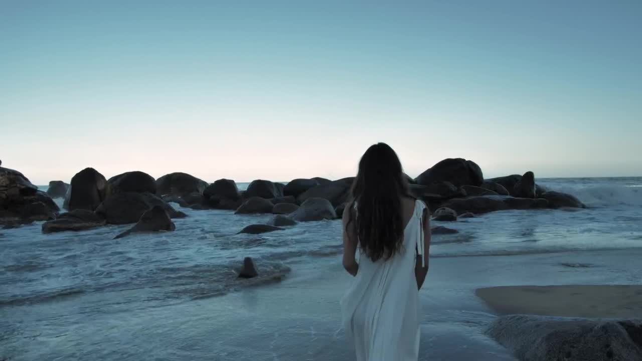 Stock Footage Woman Walking On Beach Towards Boulders Live Wallpaper Free