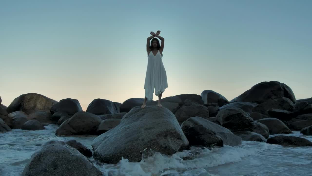 Stock Footage Woman Standing On Big Rocks Near The Water Live Wallpaper Free