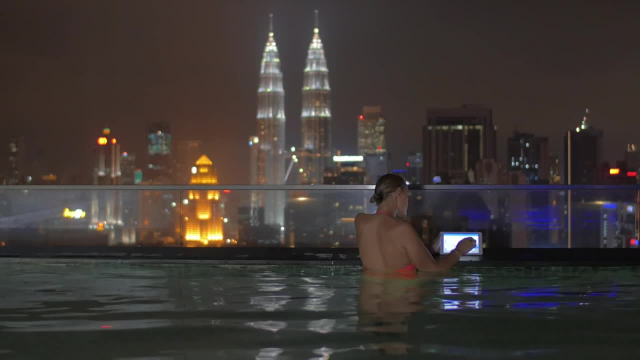 Stock Footage Woman Using Her Tablet In An Infinity Pool Live Wallpaper Free