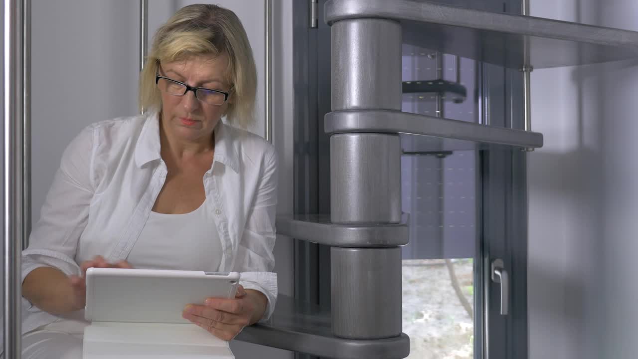 Stock Footage Woman Smiling As She Checks Her Tablet Live Wallpaper Free