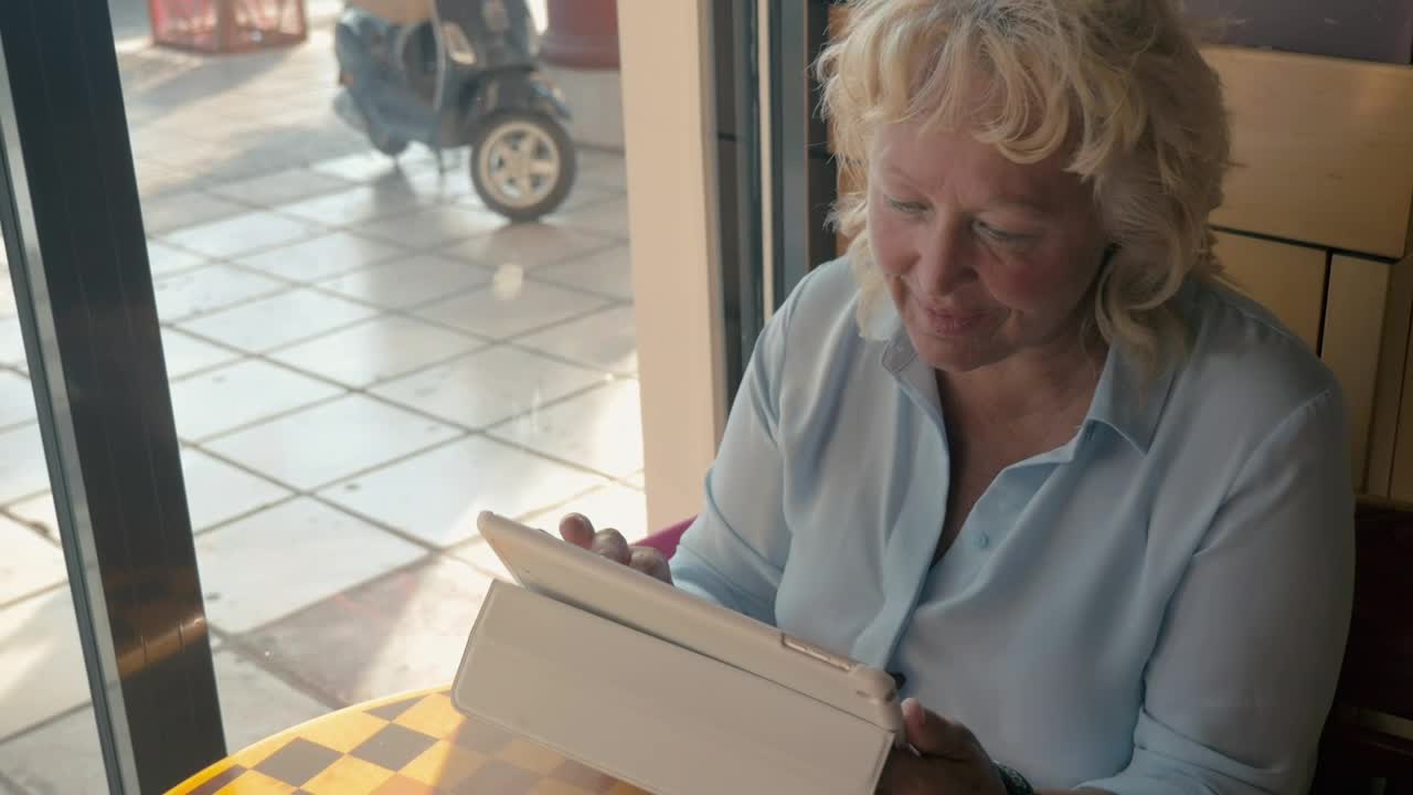 Stock Footage Woman Using A Tablet From A City Cafe Live Wallpaper Free
