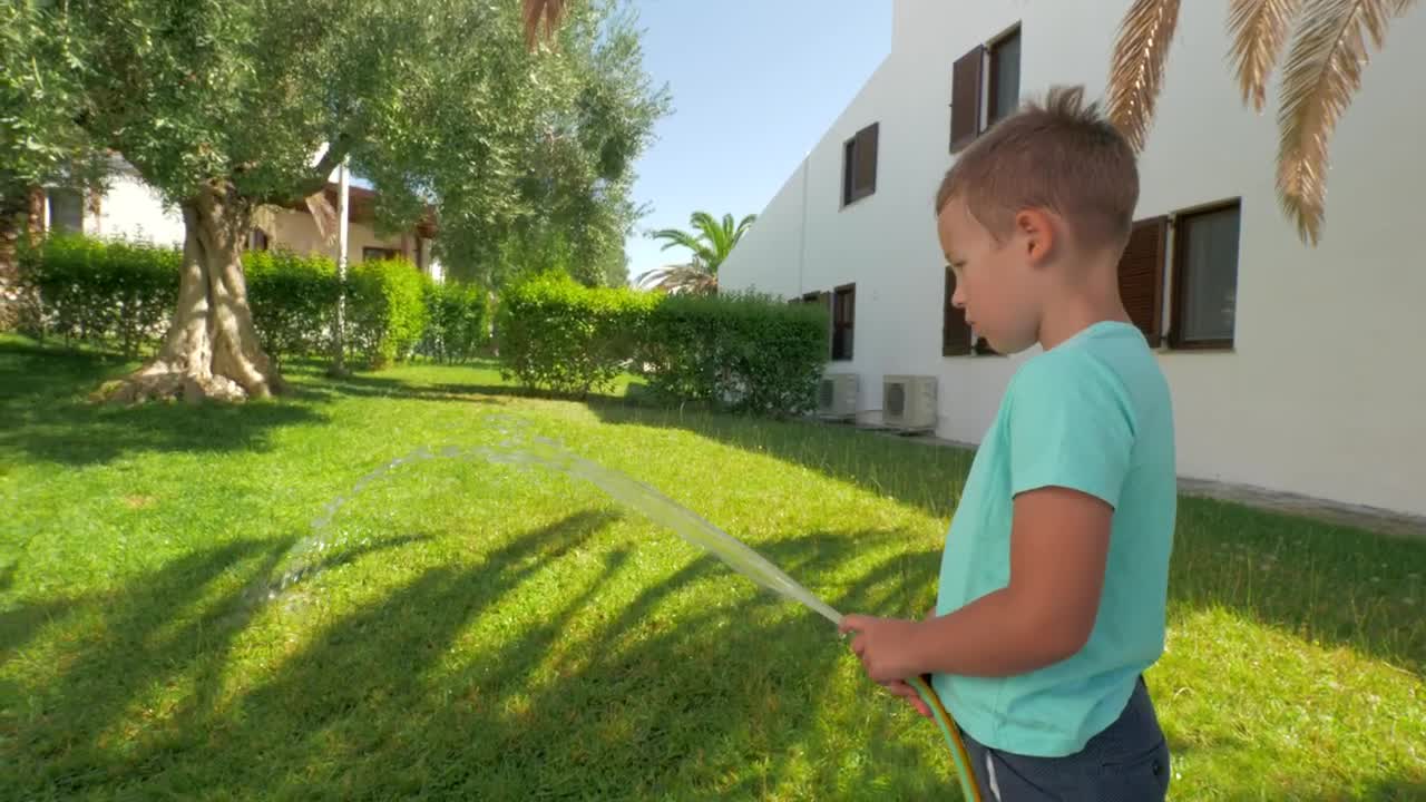 Stock Footage Young Boy Watering Grass Live Wallpaper Free