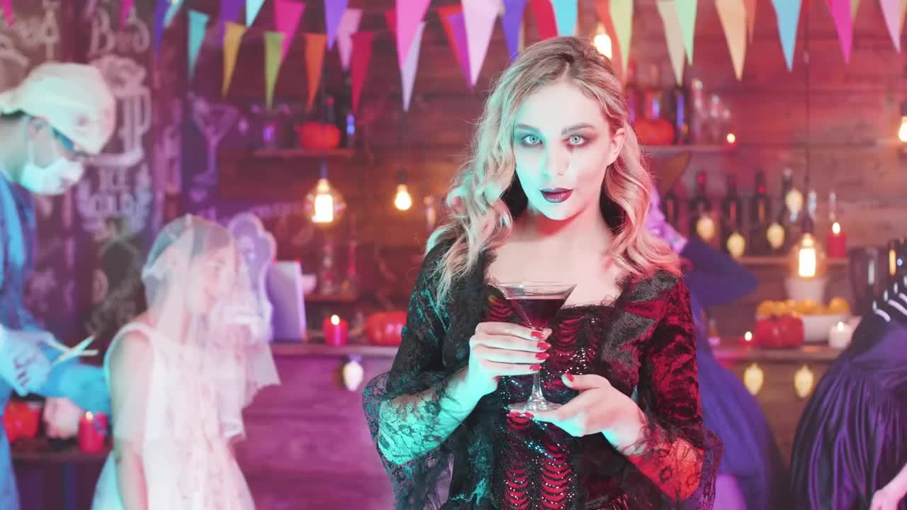 Stock Footage Woman Drinking At A Halloween Party Live Wallpaper Free