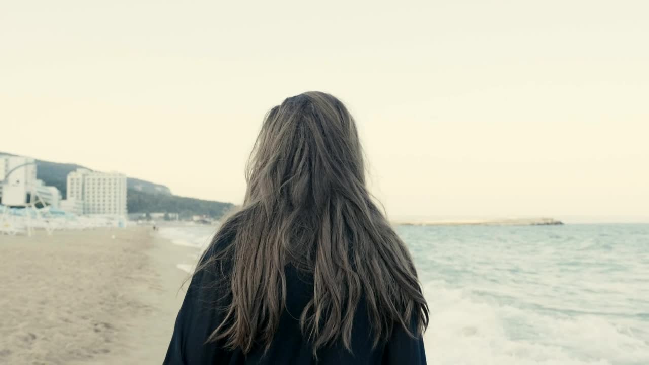 Stock Footage Woman Walking Along A Coastal Town Beach Live Wallpaper Free