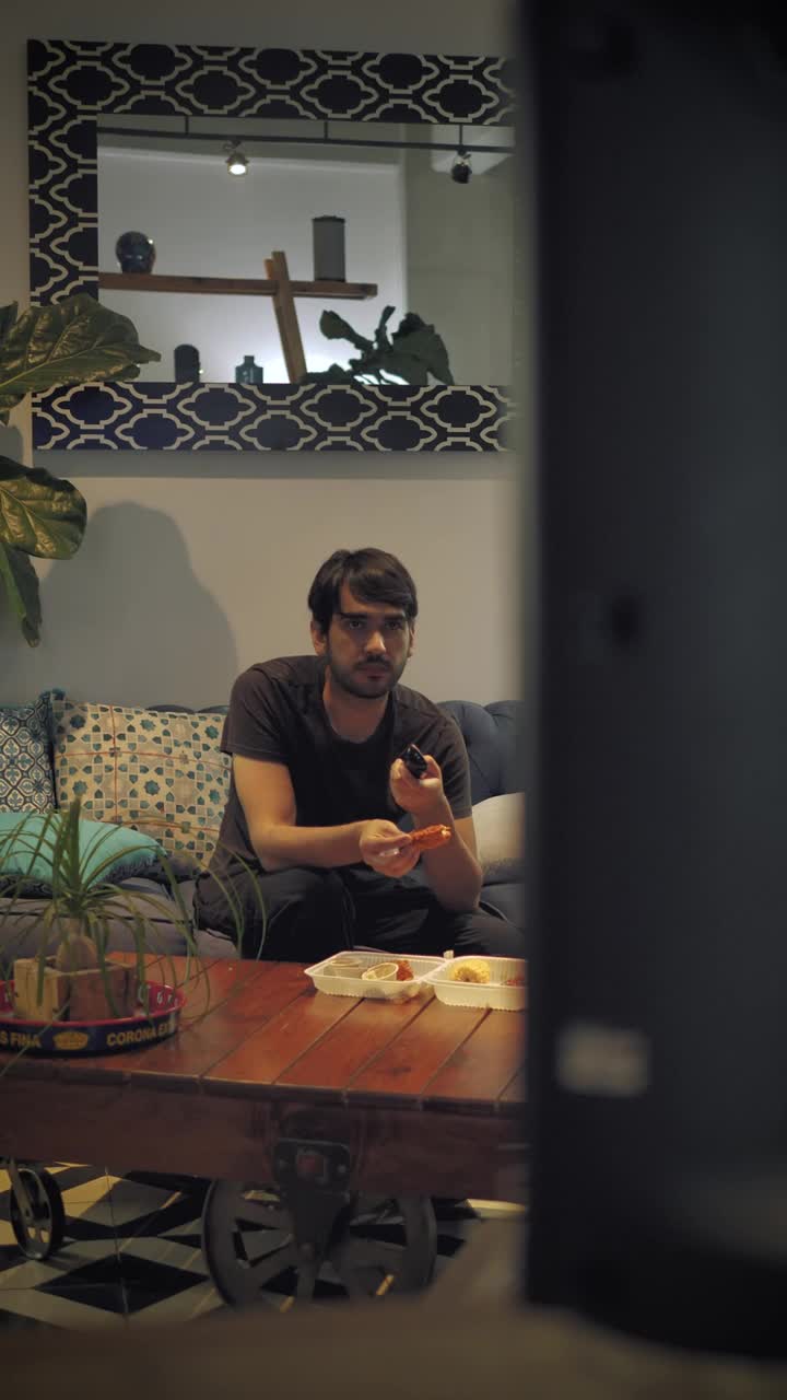 Stock Footage Young Man Watching Television While Eating Live Wallpaper Free