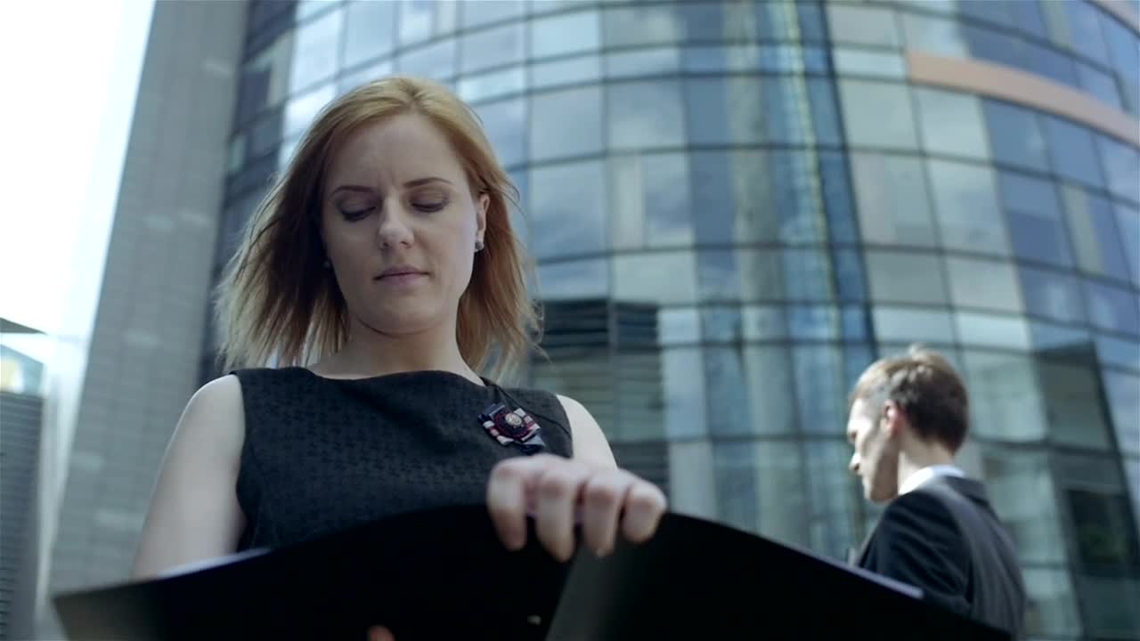 Stock Footage Woman Looking At Documents On A Windy Street Live Wallpaper Free
