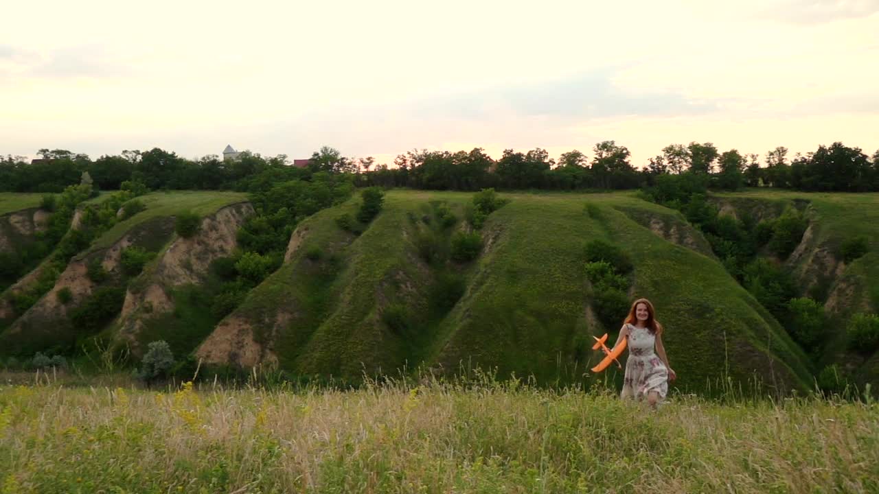 Stock Footage Woman Throwing A Toy Airplane In The Hill Live Wallpaper Free