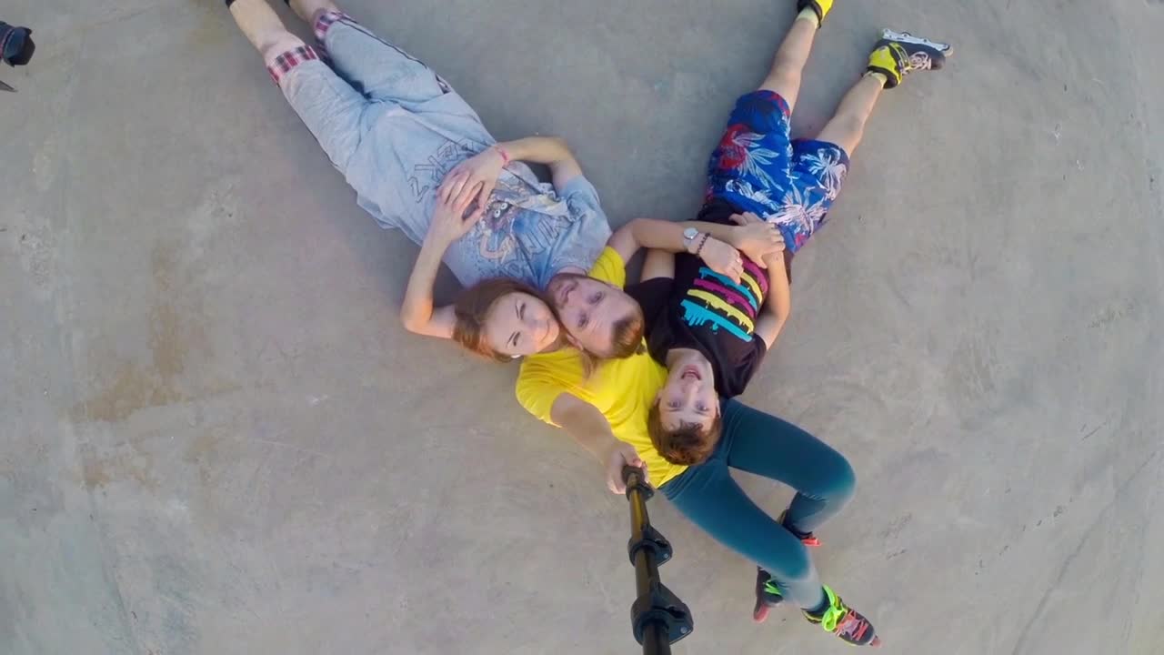 Stock Footage Young Family In Rollerskates Laying On The Ground Live Wallpaper Free